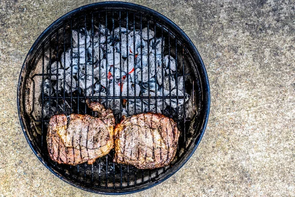 Two Seasoned Steaks Sitting Coals Small Outdoor Grill — Stock Photo, Image