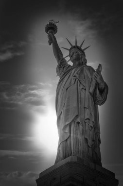 New York 'taki Özgürlük Anıtı' nın arkasından güneş parlıyor..
