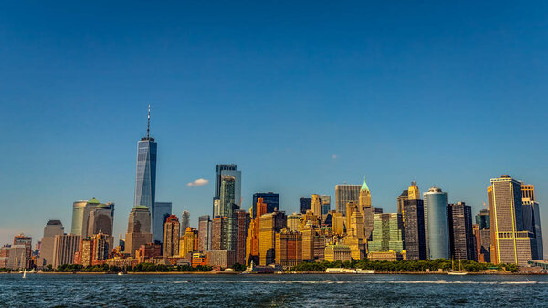 The skyline of New York City on a hot summer day from the Upper Bay from a ferry.