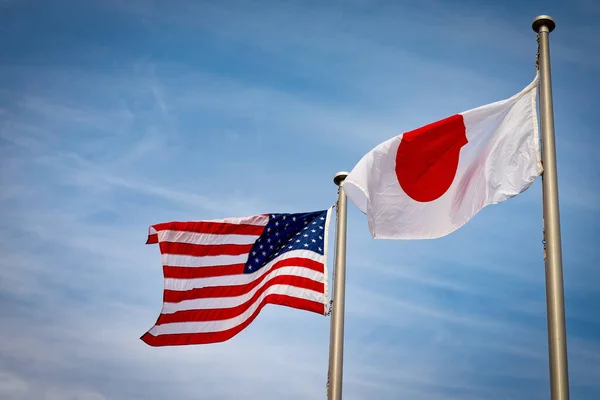The American and Japanese flags fly side by side in Yokosuka, Japan.