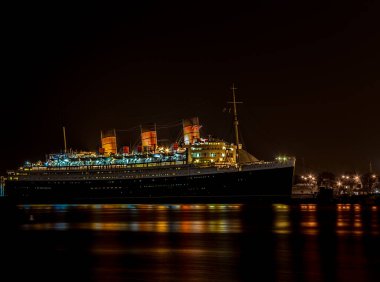 RMS Kraliçesi Mary akşam saatlerinde ışıklarıyla kenetlendi..