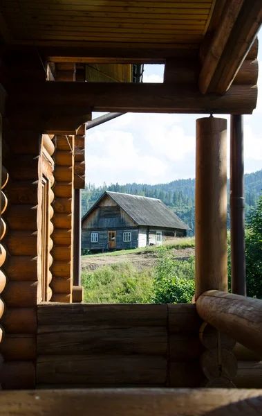 Summer landscape view in the mountains village with wooden houses. Carpathian mountains, Ukraine.