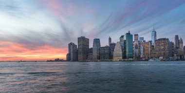 Manhattan 'ın Finansal Bölgesi, New York, ABD' deki Brooklyn Köprü Parkı 'ndan gece gökyüzüne yükseliyor.