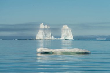 Stranded icebergs at the mouth of the Icefjord near Ilulissat, Greenland clipart