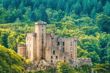 Dunvegan Castle on the Isle of Skye, Highlands of of Scotland. Seat of the MacLeod Clan. Built on an elevated rock overlooking an inlet on the eastern shore of the sea Loch of Dunvegan. clipart