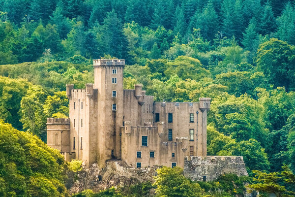 Dunvegan Castle on the Isle of Skye, Highlands of of Scotland. Seat of the MacLeod Clan. Built on an elevated rock overlooking an inlet on the eastern shore of the sea Loch of Dunvegan.