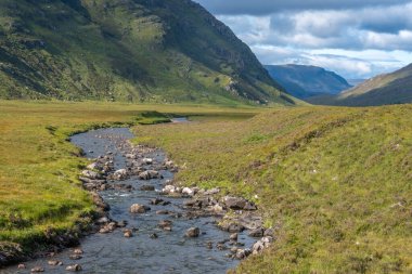 Hiking the Torridon Hills, made of some of the oldest rocks in the world and among the most spectacular peaks in the British Isles. Highlands of Scotland. clipart