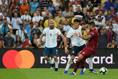 Rio de Janeiro, Brazil, June 28, 2019.The soccer players dispute the ball, during the Venezuela vs Argentina match for Copa America 2019, in the Maracan stadium.