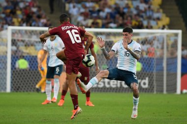 Rio de Janeiro, Brazil, June 28, 2019.The soccer players dispute the ball, during the Venezuela vs Argentina match for Copa America 2019, in the Maracan stadium.