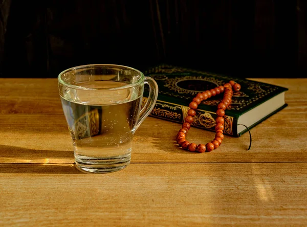 Glass Clear Water Stone Rosary Green Gilded Book Quran Table — Stock Photo, Image