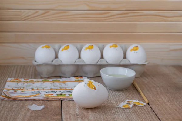 Decorating white eggs for Easter using decoupage technique.