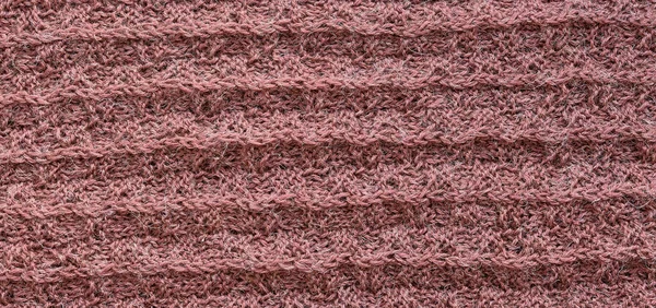 Hand-knitted wool coral fabric texture as background.