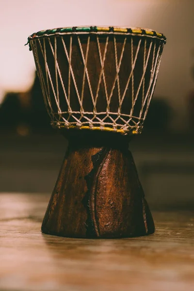 Brazilian Drum over a wood table ready to play music.