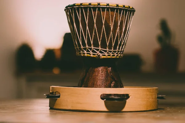 Brazilian Drum over a wood table ready to play music with a tambourine