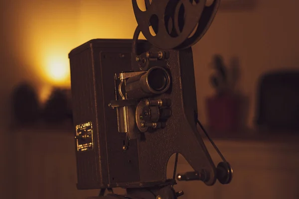 A close up of an old film projector over a table