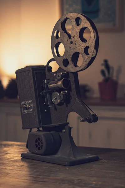 An old film projector over a table