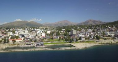 Arjantin 'in Bustillo güzergahında, şehrin merkezine yakın güneşli bir yaz gününde ağaçlar ve bitkilerle çevrili Ironman triatlonunda yarışan bisikletçi..