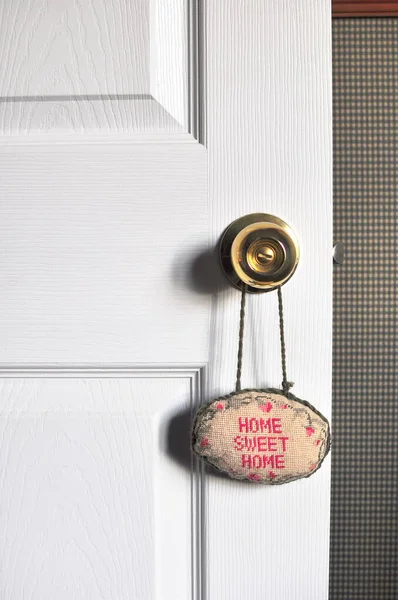 Home Sweet Home sign hanging on a door isolated home decor