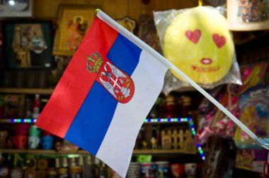 Sokobanja, Serbia, May 02, 2018: traditional outdoor store with serbian flag and various products and hand made small souvenirs from wood on sale for tourists  clipart