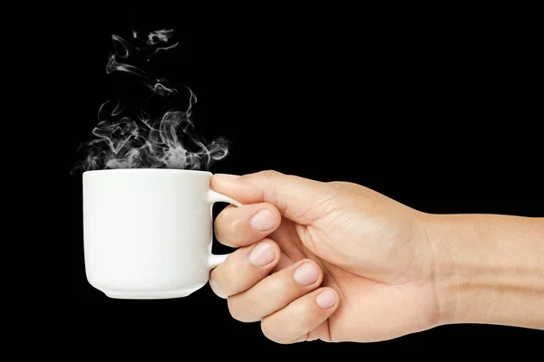 man hand holding white coffee cup with steam or hot drink in mug isolated on black background. clipping path