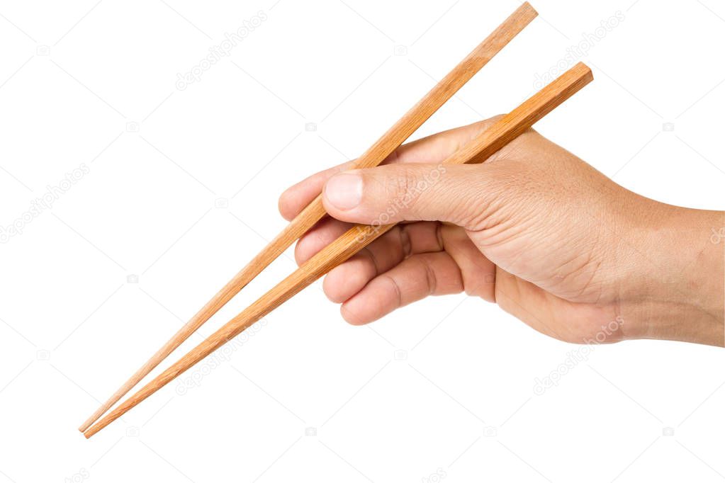 hand holding wooden chopsticks isolated on white background with clipping path