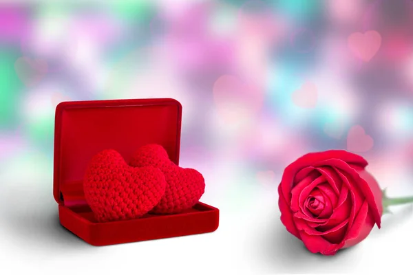 red heart in red box and red rose on abstract background, valentine\'s day background