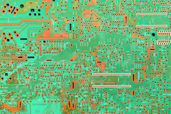 A green circuit board with copper traces. There are no components on the board.