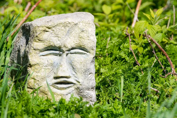Face Carved Block Greyish Stone Block Resting Grass Bright Sunny — Stock Photo, Image