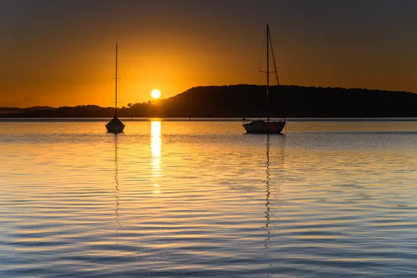 Orange Sunrise with Boats at Koolewong Waterfront on the Central Coast, NSW, Australia.