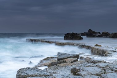 Central Coast, NSW, Avustralya 'daki Forresters Plajında Bulutlu Gün Doğumu Deniz Pelerini.
