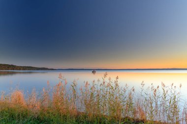 Sunset over Tuggerah Lake from Canton Beach on the Central Coast of NSW, Australia. clipart