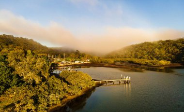 Early morning fog drifts over Horsfield Bay. Aerial capture from Correa Bay at Woy Woy. NSW, Australia clipart