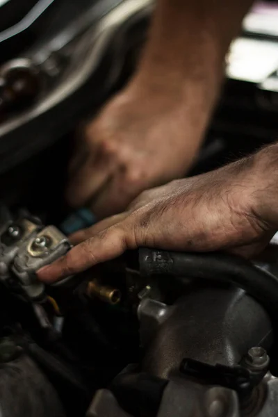 Auto mechanic working on spare parts for a car