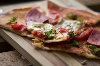 Jambonlu pizza, domates peyniri ve brokoli.