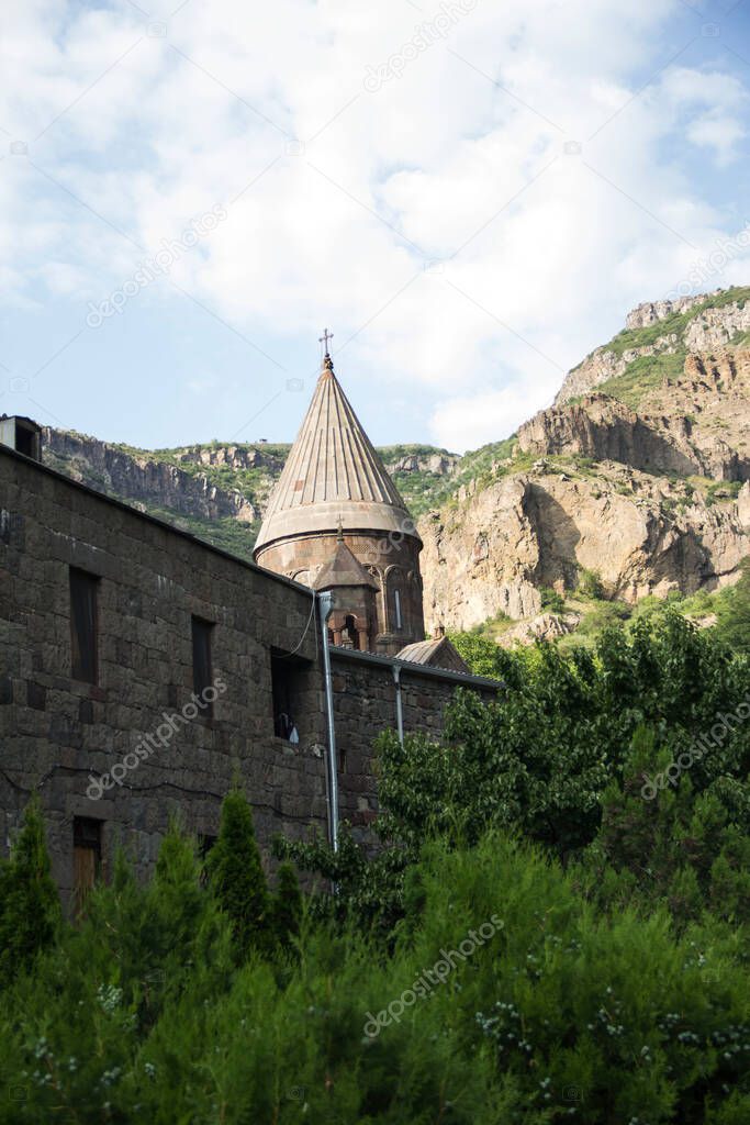 Armenian church Saint Geghard among trees and mountains
