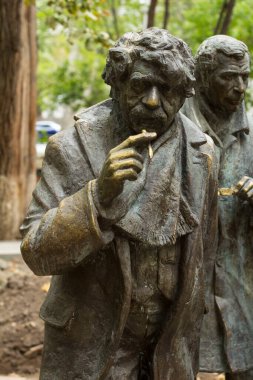 Dumanlı bıyıklı bir adamın heykeli.