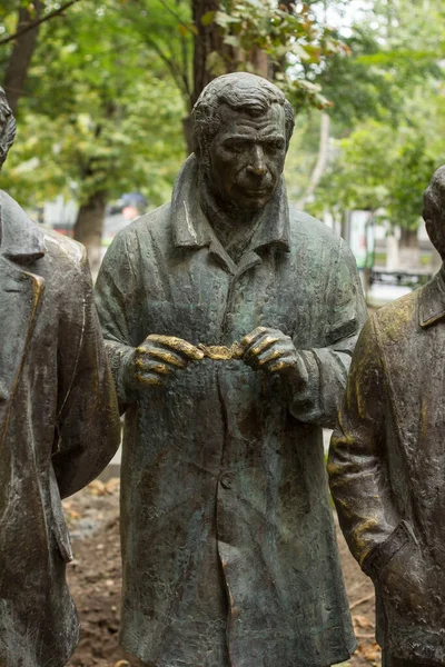 Statue of a man opening a candy bar