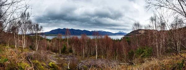 Mountain range over a lake on a cloudy day in Highlands, Scotland