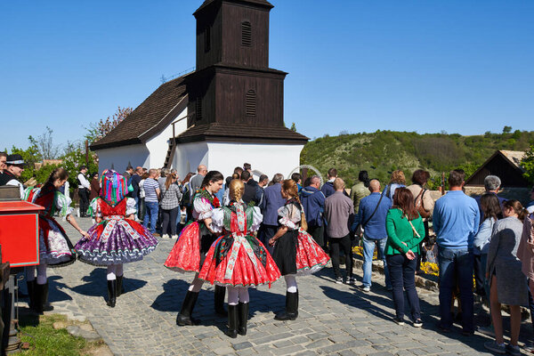 Local girls in a traditional folk dresses during an Easter Holy Mass in an old village - Holloko, Hungary country