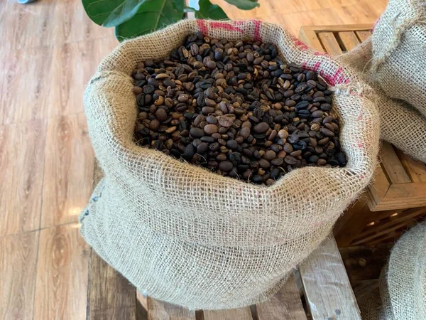 Roasted coffee beans in brown sacks