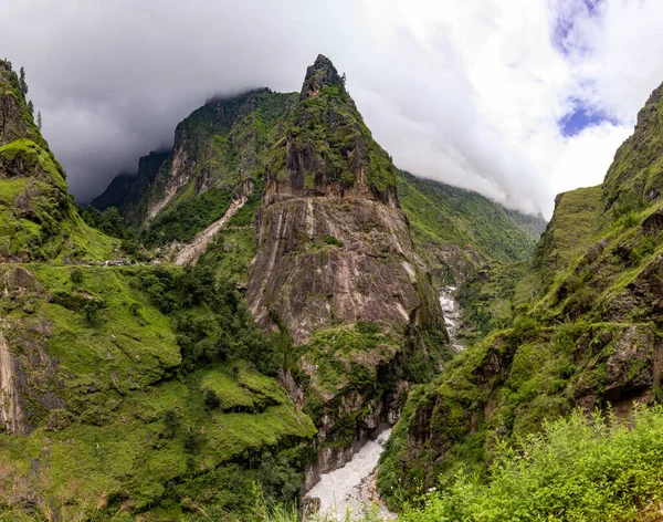 Nepal 'deki Annapurna yürüyüşündeki bir nehrin üzerindeki dağ sırasının panoramik görüntüsü
