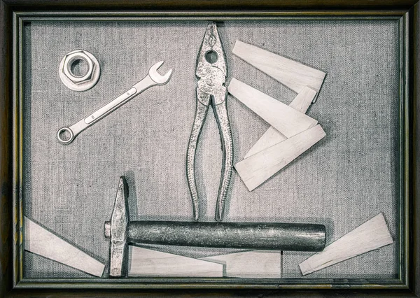 art painting of construction tools (hammer, pliers, wrench) on l