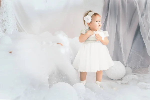 Little girl stands against the background of New Year — Stock Photo, Image