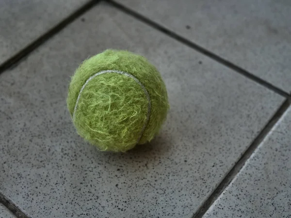 Green Old Tennis Ball Gray Background — Stock Photo, Image