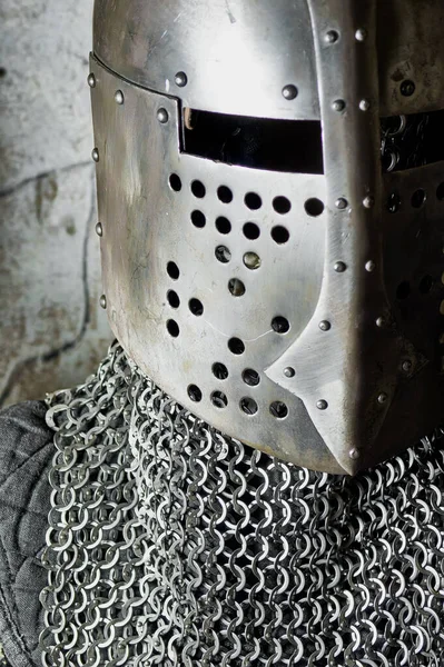 metal knight\'s helmet and chain mail on wall bakground