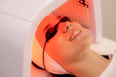 Led phototherapy for the face. LED lamp for photodynamic therapy. Face care. Light therapy at home. clipart