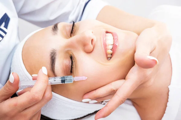 A photo of acne treatment. Mesotherapy and biorevitalization of the face. Wrinkle treatment. Rejuvenation of the skin of the face. Botulinum toxin injection.