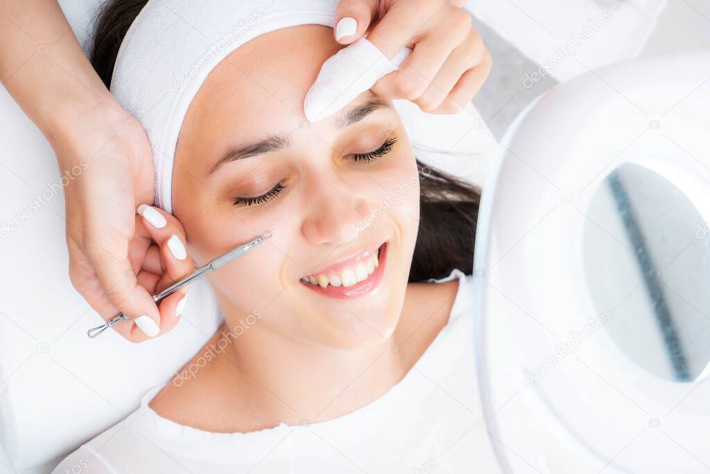 Photo facial cleansing at the beautician. Mechanical face cleaning photo. Combined facial cleansing.