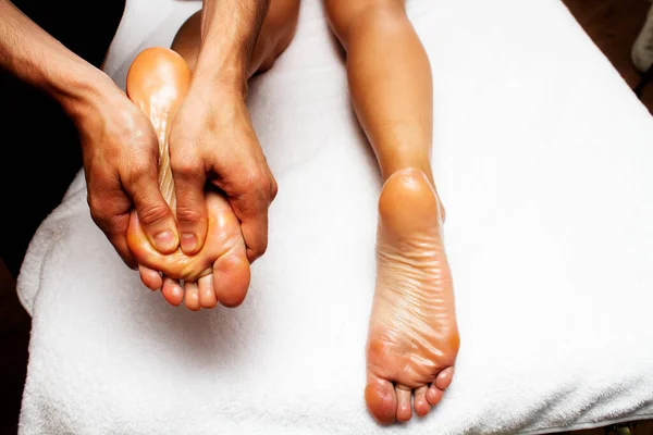 Male hands making anti-cellulite foot massage for woman. Slimming legs and hips