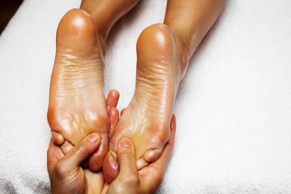 Male hands making anti-cellulite foot massage for woman. Slimming legs and hips